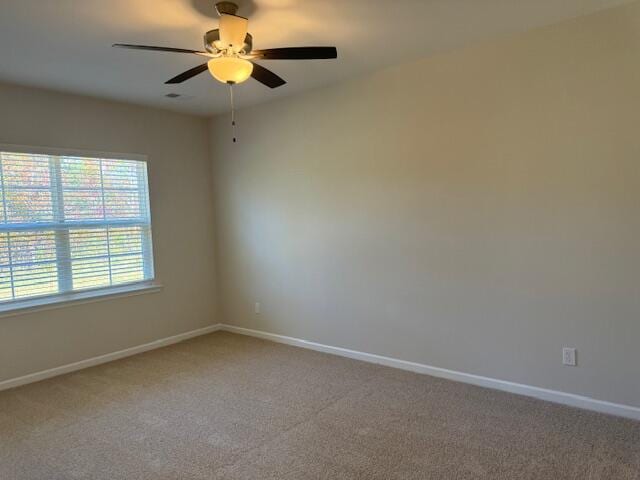 empty room with ceiling fan and carpet floors