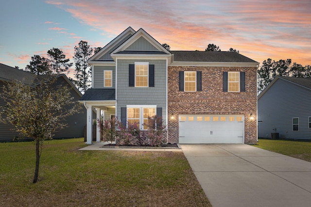 686 Redbud Ln, Summerville, SC 29486 - traditional-style home with central air condition unit, an attached garage, driveway, a shingled roof, and a lawn