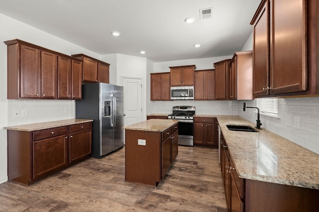 686 Redbud Ln, Summerville, SC 29486 - kitchen with dark wood-style flooring, stainless steel appliances, a center island, a sink, and visible vents