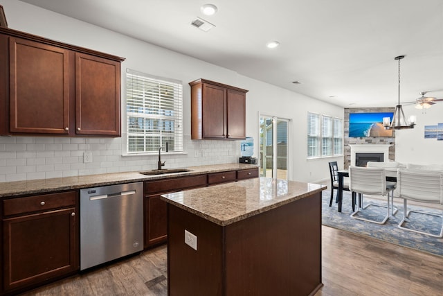 686 Redbud Ln, Summerville, SC 29486 - kitchen with dark wood-type flooring, decorative backsplash, stainless steel dishwasher, a sink, and visible vents