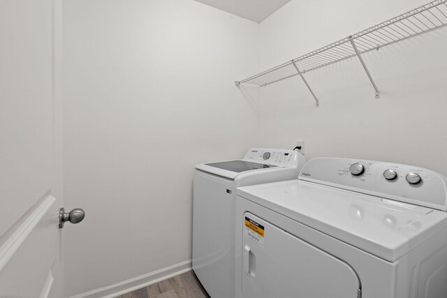 686 Redbud Ln, Summerville, SC 29486 - clothes washing area featuring independent washer and dryer, wood finished floors, laundry area, and baseboards