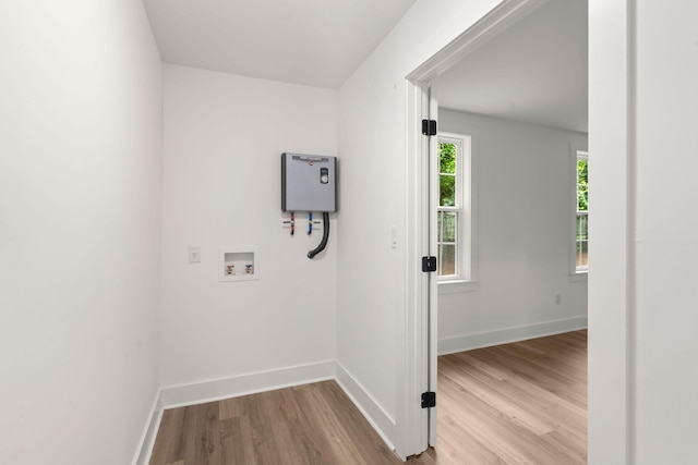 clothes washing area with washer hookup and light hardwood / wood-style floors