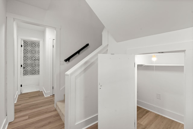 stairs featuring hardwood / wood-style floors