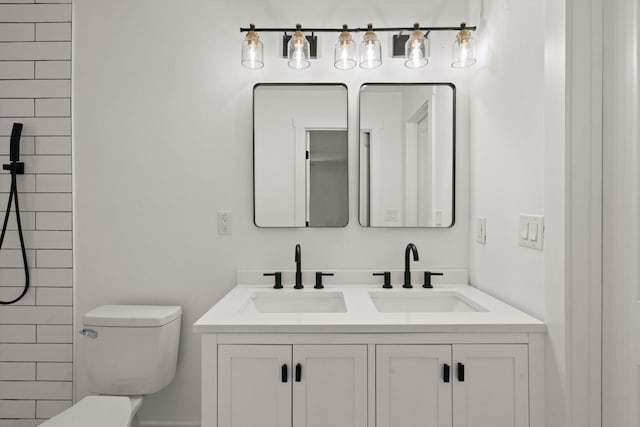 bathroom with vanity, toilet, and a tile shower