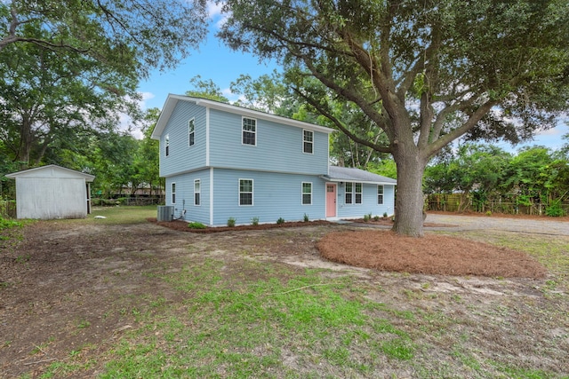 view of front of property with a shed and central AC unit