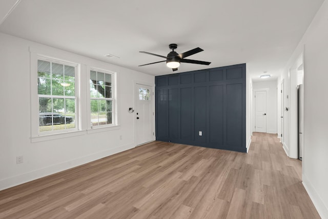 unfurnished living room featuring light hardwood / wood-style floors and ceiling fan