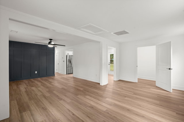 unfurnished living room featuring ceiling fan and light wood-type flooring