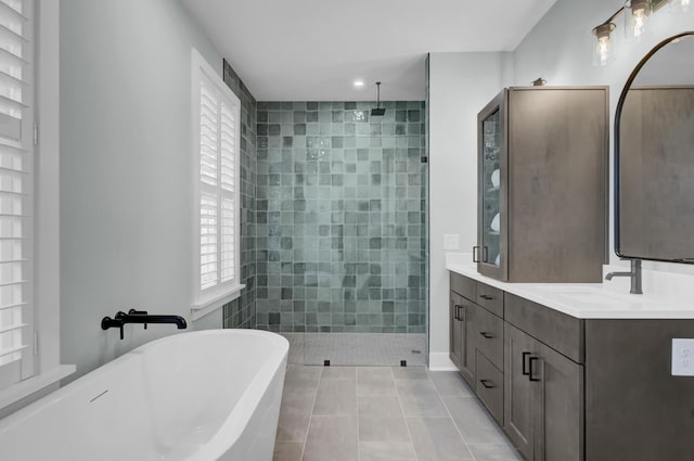 bathroom featuring vanity, tile patterned flooring, and shower with separate bathtub