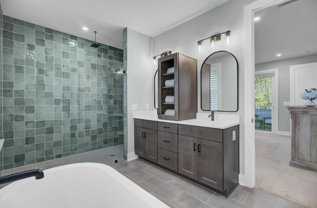 bathroom with tile patterned floors, vanity, and independent shower and bath