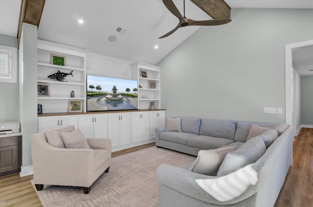 living room featuring beam ceiling, high vaulted ceiling, ceiling fan, and light wood-type flooring