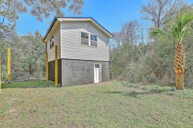 view of side of home featuring a yard