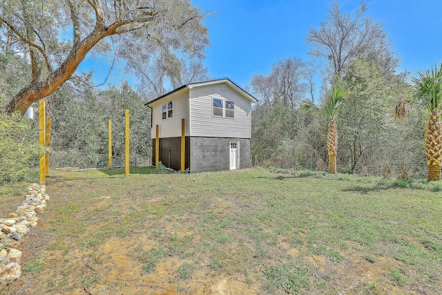 view of side of property with a yard