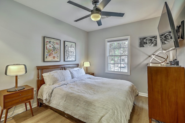 bedroom featuring a ceiling fan, wood finished floors, and baseboards