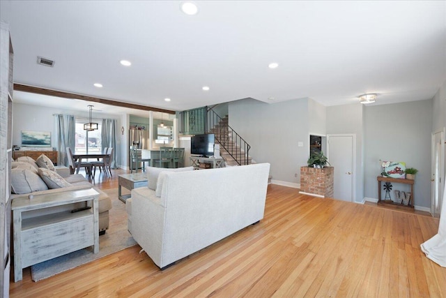 1115 O T Wallace Blvd, Moncks Corner, SC 29461 - living area with light wood-style floors, stairway, recessed lighting, and baseboards
