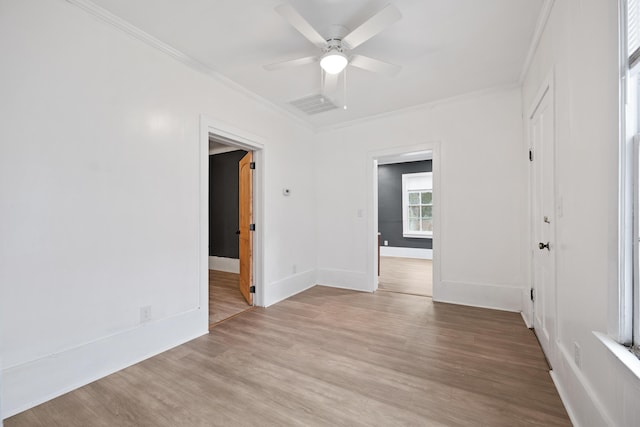 spare room with crown molding, ceiling fan, and light hardwood / wood-style flooring