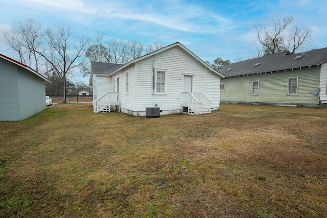 rear view of house featuring a yard