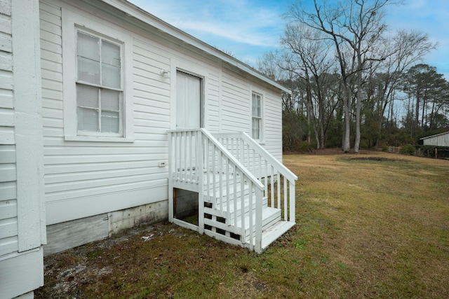 view of side of home with a lawn