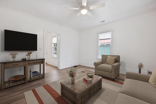 living room featuring crown molding, ceiling fan, and hardwood / wood-style floors