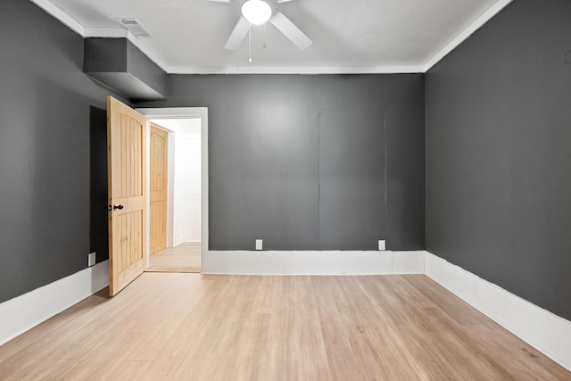 unfurnished room with ornamental molding, ceiling fan, and light wood-type flooring