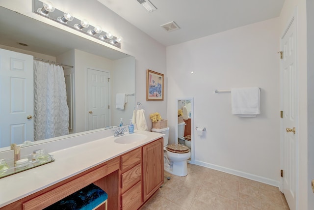 full bath featuring toilet, vanity, visible vents, and baseboards