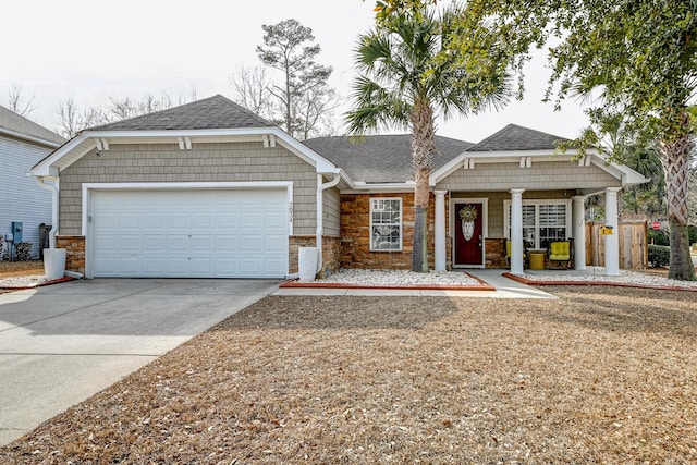 view of front of home with a garage, concrete driveway, a shingled roof, and stone siding