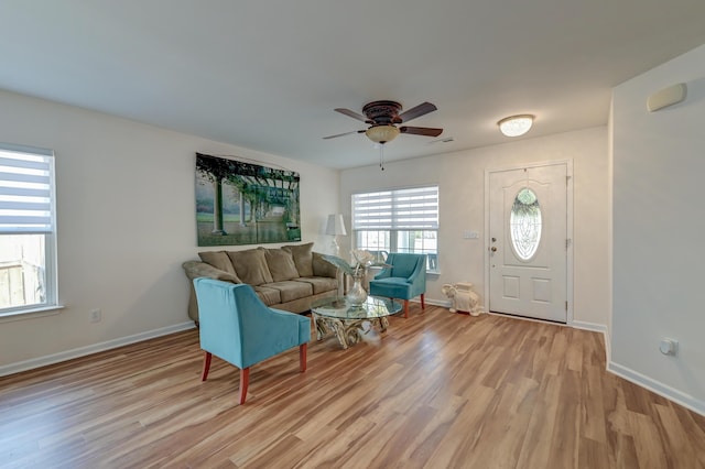 entryway with light wood-style floors, visible vents, baseboards, and a ceiling fan