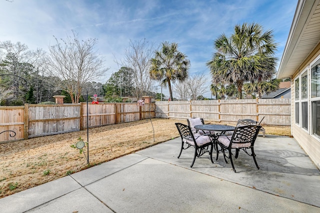 view of patio featuring a fenced backyard and outdoor dining area