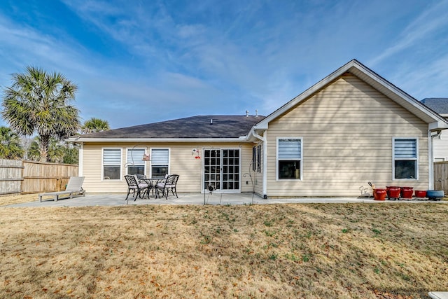 back of house featuring a yard, fence, and a patio