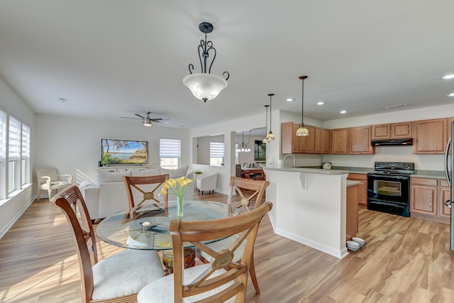 dining area with light wood-style flooring, baseboards, a ceiling fan, and recessed lighting