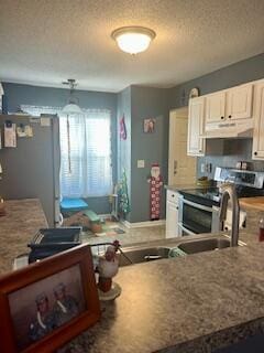 kitchen featuring stainless steel appliances and a textured ceiling