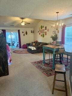 dining area featuring ceiling fan with notable chandelier