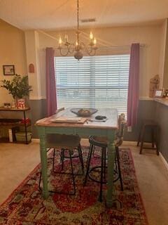 dining room featuring a wealth of natural light and a notable chandelier