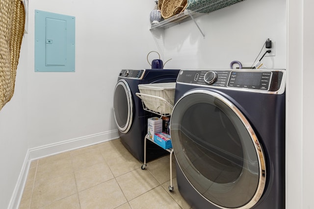 laundry room with electric panel, separate washer and dryer, light tile patterned flooring, baseboards, and laundry area