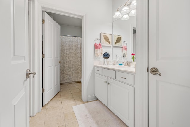 full bath featuring vanity and tile patterned flooring