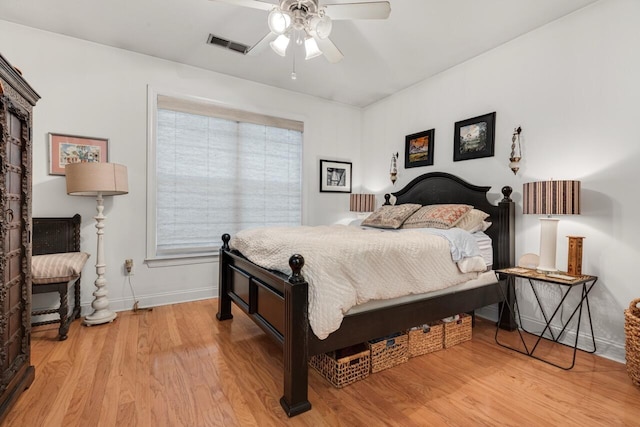 bedroom with visible vents, baseboards, light wood-style flooring, and a ceiling fan