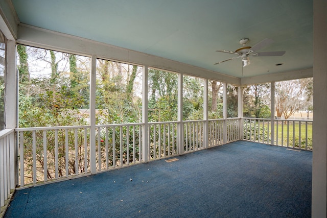 unfurnished sunroom featuring ceiling fan