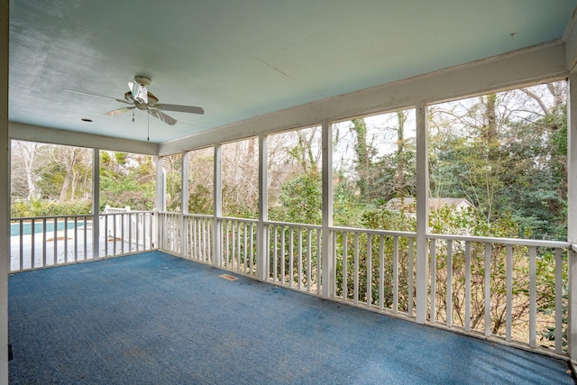 unfurnished sunroom featuring ceiling fan and visible vents