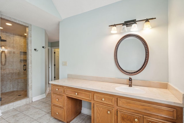 bathroom with vaulted ceiling, a stall shower, vanity, and tile patterned floors