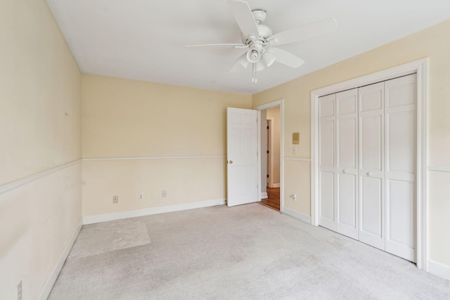 unfurnished bedroom featuring a closet, carpet flooring, ceiling fan, and baseboards