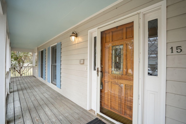 view of exterior entry with covered porch