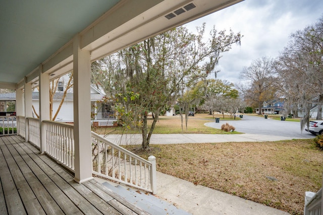 deck with a lawn and visible vents