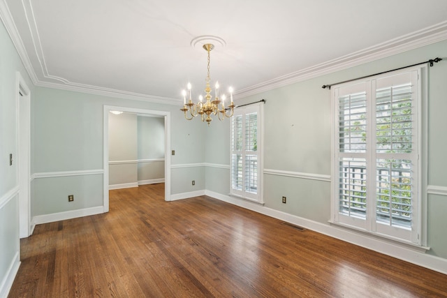 unfurnished room with a healthy amount of sunlight, visible vents, and wood finished floors