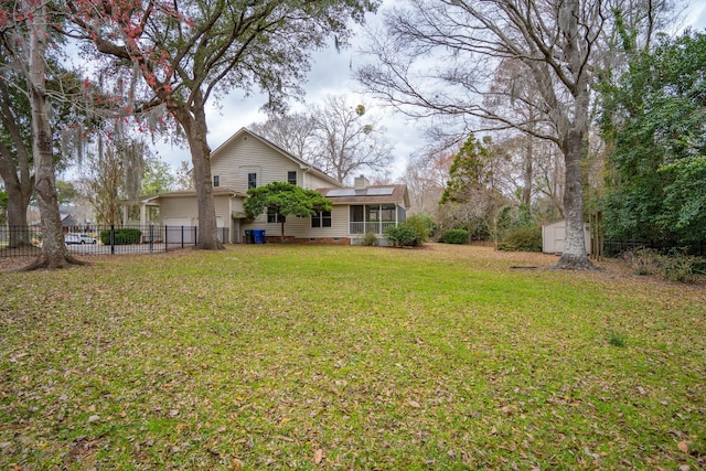 view of yard with a storage shed, an outdoor structure, and fence