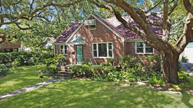 english style home featuring a front lawn