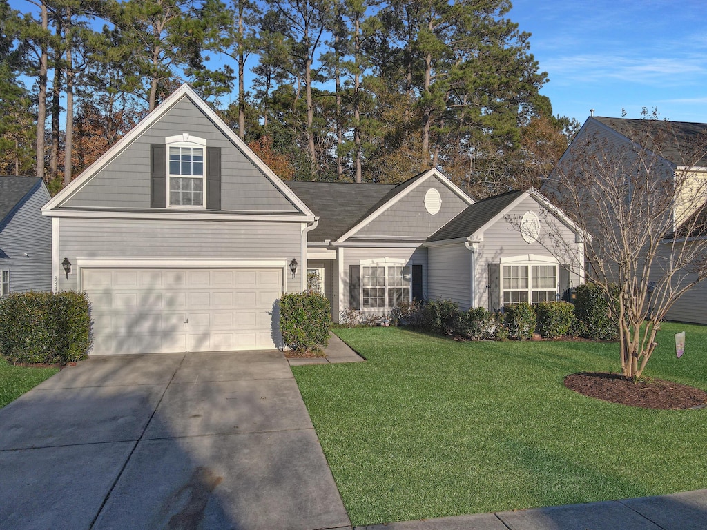 view of front of property with a front yard and a garage