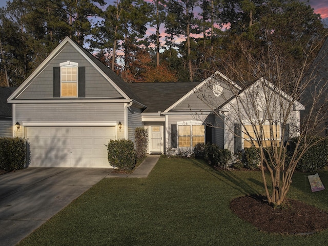 view of front of house featuring a lawn and a garage