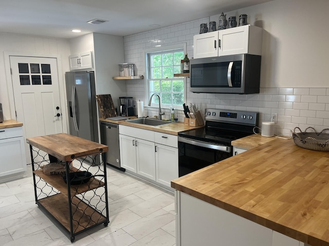 1866 Ashley Hall Rd, Charleston, SC 29407 - kitchen with wooden counters, appliances with stainless steel finishes, a sink, light marble finish floors, and white cabinetry