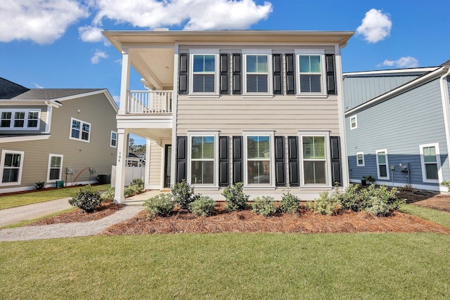 exterior space with a lawn and a balcony