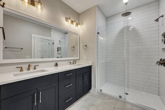 bathroom featuring marble finish floor, double vanity, a sink, and a shower stall