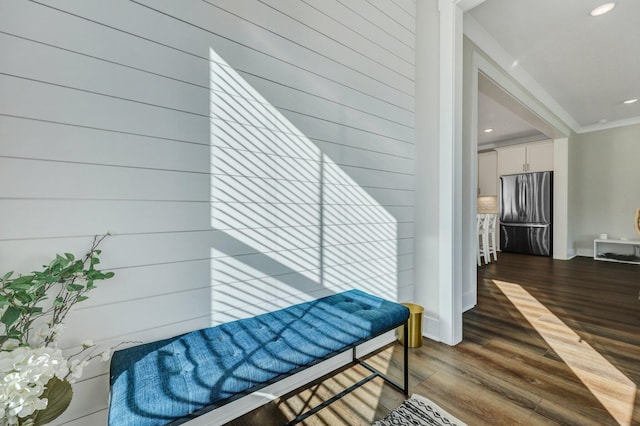 interior space featuring ornamental molding, recessed lighting, and dark wood finished floors